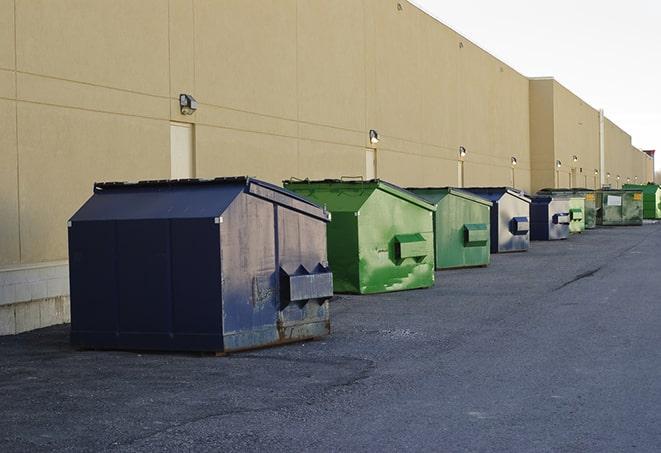 a row of heavy-duty dumpsters ready for use at a construction project in Auburn